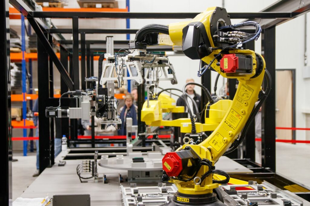 Robotyzacja procesów produkcyjnych – robot przemysłowy z chwytakiem na stanowisku zrobotyzowanym